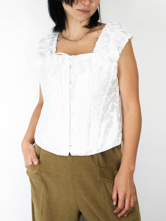 Білий корсет із рюшами