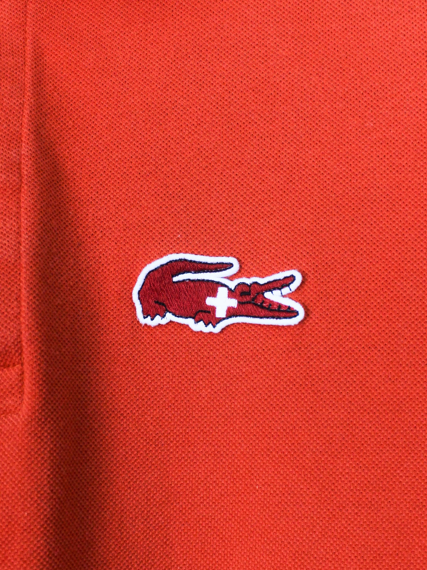 Помаранчеве поло Lacoste